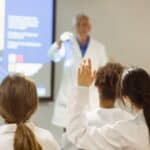 Medical students sitting in a classroom listening to a lecture