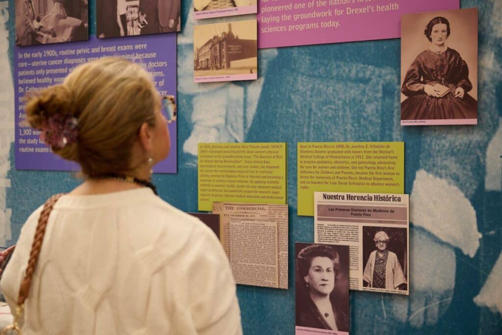 A visitor at the historical exhibit on the second floor of Drexel's Health Science Building