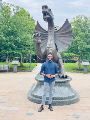 Samuel Dada, visiting scholar, in front of the Mario statue on Drexel's University City Campus